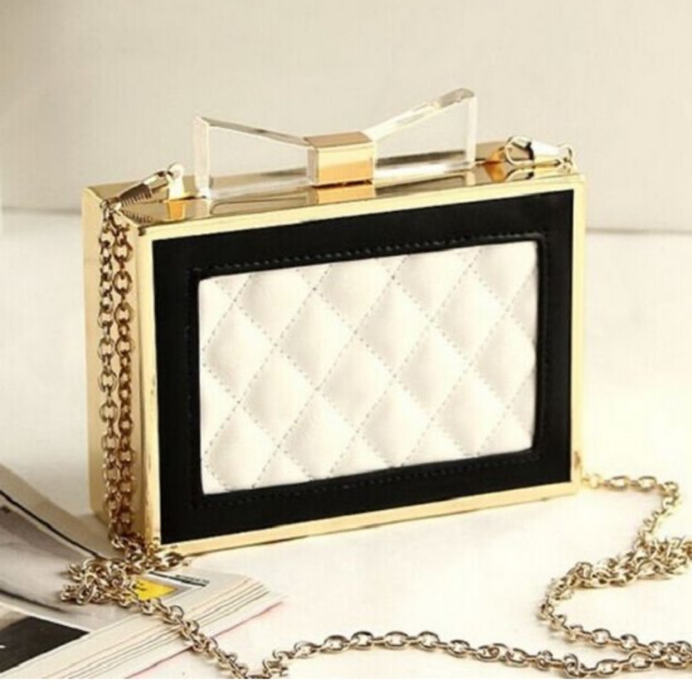 metal framed quilted faux leather frame clutch with acrylic bow.